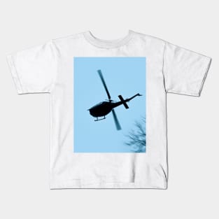 A Bell UH-1 Huey Iroquois flying low over trees Kids T-Shirt